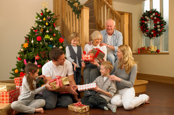 happy-family-and-grandparents-handing-out-presents-on-christmas-day